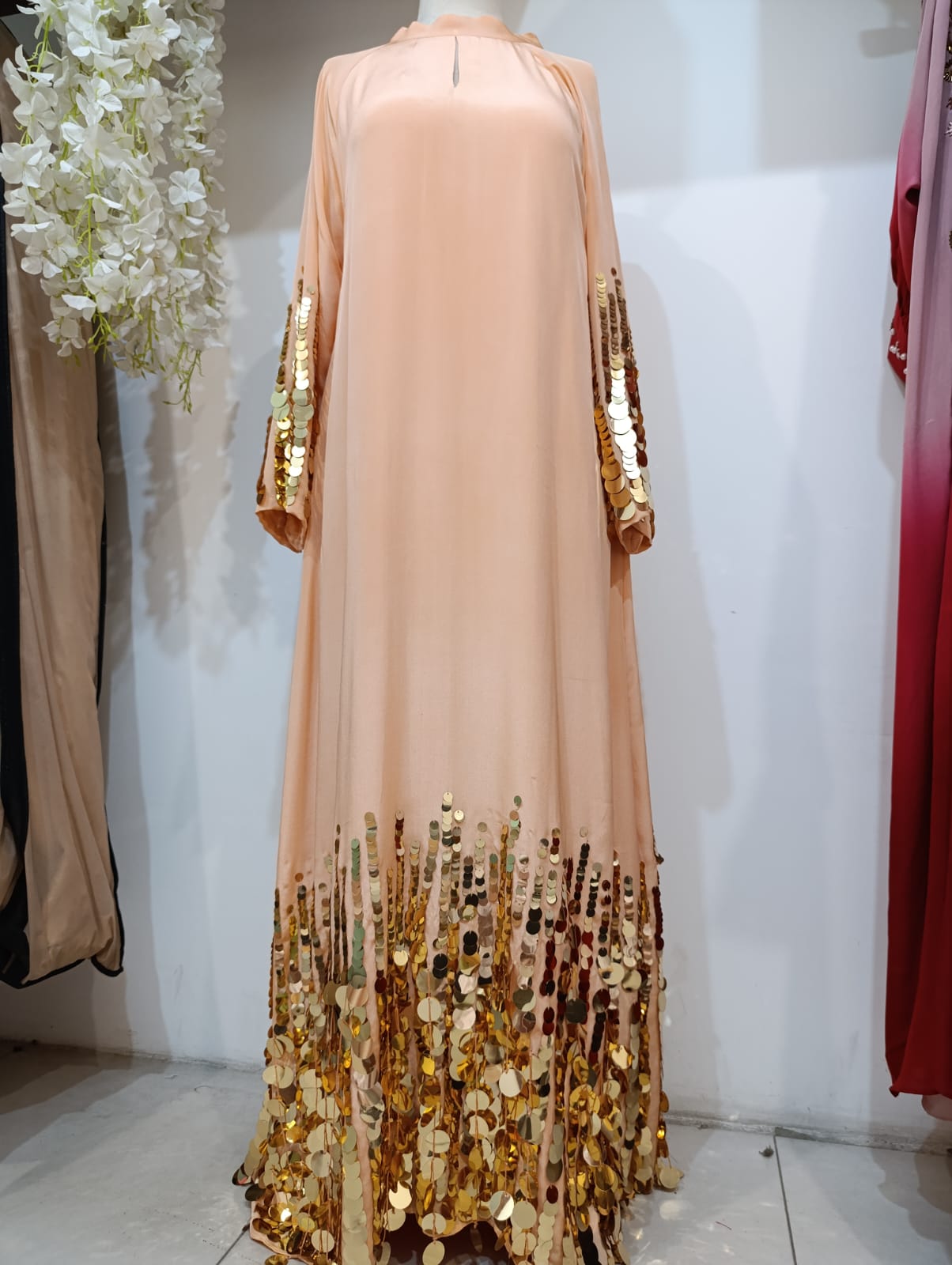 Peach chiffon abaya with dramatic gold paillette embellishment on sleeves and hem