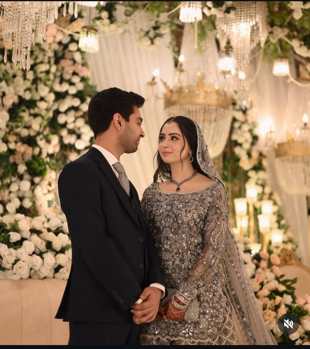 Bride and groom in silver embellished reception wear by Sameera's Collection